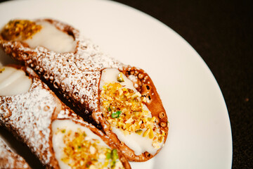 Cannoli are Italian pastries consisting of tube-shaped shells of fried pastry dough, filled with a sweet, creamy filling usually containing ricotta—a staple of Sicilian cuisine. Palermo, Sicily, Italy