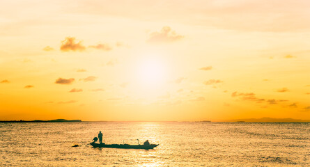 silhouette of a person on a boat at sunset sky over sea