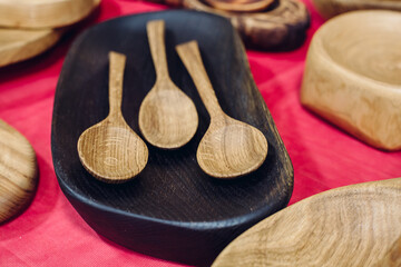 Obraz na płótnie Canvas spoons made of wood, kitchen accessories made of wood, eco-friendly tableware, set of wooden spoons, carved from wood by a carpenter
