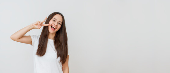Fototapeta premium Close-up portrait of young woman. Big smile, beautiful model posing in studio over white background.
