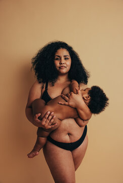 Plus size mother breastfeeding her baby