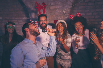 Friends having fun at New Year's Eve karaoke party