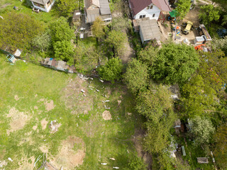 Fototapeta na wymiar Aerial drone top view. A green meadow among the private sector.