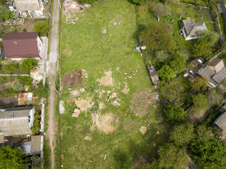 Aerial drone top view. A green meadow among the private sector.