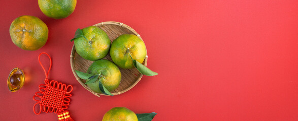 Top view of fresh tangerine mandarin orange on red background for Chinese lunar new year.
