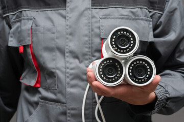 CCTV cameras in the worker hand close up.