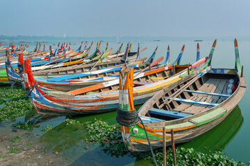Fototapeta na wymiar Colorful traditional wooden row boats in Amapura, near U Bein bridge, Mandalay, Burma Myanmar
