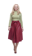 young woman in a fashionable outfit striding forward.