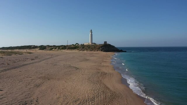 Aerial drone flight over the marvelous long sand beach at the Cape of trafalgar in south Spain seen from above in a summer morning