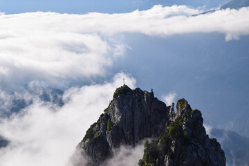 Stunning summit cross with fog in Lechtal Alps Tyrol, Austria