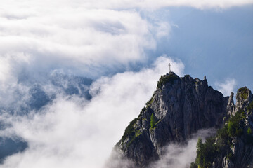 Stunning summit cross with fog in Lechtal Alps Tyrol, Austria