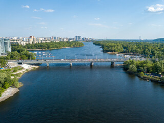 Obraz premium Aerial drone view. Automobile bridge over the Dnieper river in Kiev.