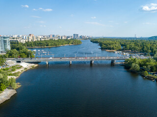 Fototapeta premium Aerial drone view. Automobile bridge over the Dnieper river in Kiev.