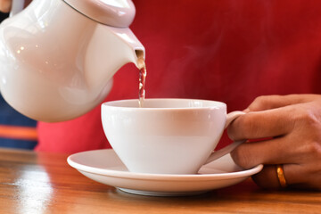 Ready to eat, White teapot and glass tea set on a wooden table.