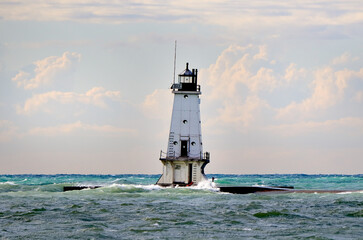 White lighthouse and breakwater © John Wijsman