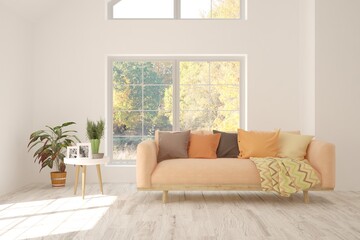 Stylish room in white color with sofa and autumn landscape in window. Scandinavian interior design. 3D illustration