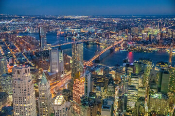 Amazing night aerial view of Brooklyn and Manhattan Bridges, east River and skyscrapers, New York City