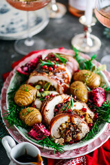 Prosciutto wrapped turkey roulade with pomergranate sauce. .style rustic.