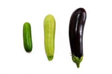 green cucumber, zucchini and purple eggplant on a white background