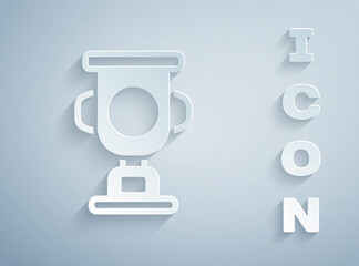 Paper cut Award cup icon isolated on grey background. Winner trophy symbol. Championship or competition trophy. Sports achievement sign. Paper art style. Vector.
