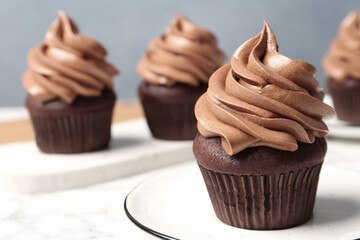 Delicious fresh chocolate cupcake on table, closeup