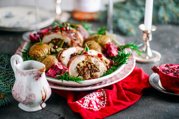 Prosciutto wrapped turkey roulade with pomergranate sauce. .style rustic.