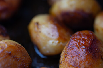 Whole fried potatoes in a pan
