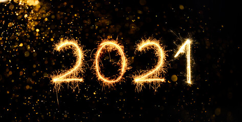 Happy New Year 2020. Number 2020 written sparkling sparklers isolated on back with bokeh background