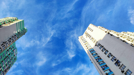 Multi-storey residential building against the blue sky. Urban landscape. Big city.