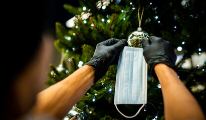decorating the Christmas tree - medical mask for the Christmas tree - coronavirus pandemic | COVID-19 | Merry Christmas - the realities of 2020