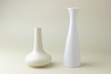 empty vases standing on beige backdrop with soft shadow