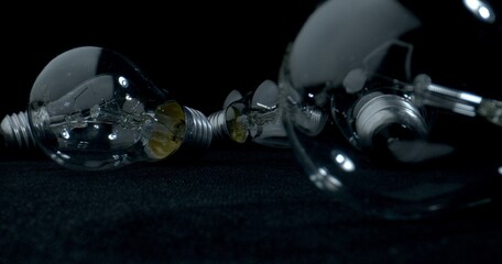Surrounded light bulbs on black table. A lot of light bulbs on black background. Technology concept. 