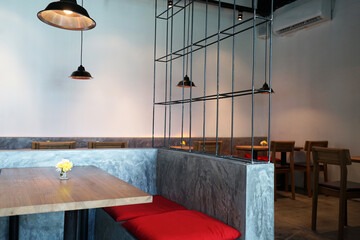 Interior design and decoration of restaurant dining area decorated with wooden furniture in industrial loft style