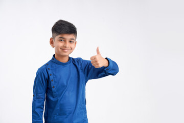 Cute indian little boy showing thumps up