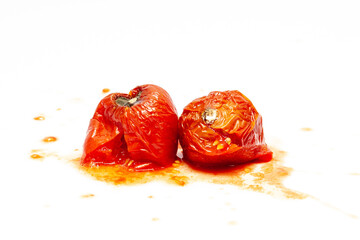 splattered rotten tomatoes isolated on white. Moldy, splashed and spoiled tomato. fruit, vegetable...