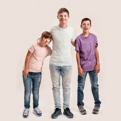 Full length shot of three cheerful teenaged disabled children with Down syndrome and cerebral palsy smiling while standing together isolated over white background