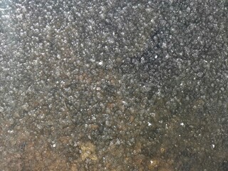 a full-frame background in the form of rough transparent ice.