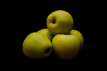 Yellow apples on dark background