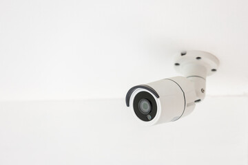 Security CCTV camera surveillance system indoor of house. A blurred night Cityscape background. Modern CCTV camera on a wall. Equipment system service for safety life or asset.