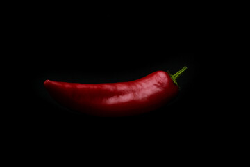 Long sweet red pepper on dark background