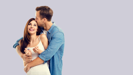 Naklejka premium Love, new parents and family concept - very happy excited couple, man and woman finding out results of pregnancy test. Isolated over grey background. Copy space.