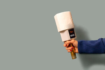 on a blue background, a journalist's microphone, instead of a sound filter, is wearing a roll of...