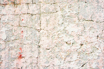 Texture of a concrete wall with cracks and scratches which can be used as a background