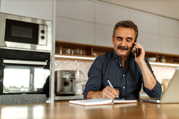 Man talking with someone over the phone.