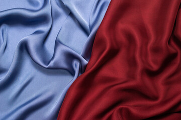 Red and blue silk or satin luxury fabric texture. Top view.