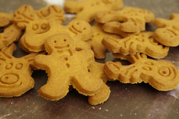 Bunch of different shaped Christmas cookies on a brown background. Closeup