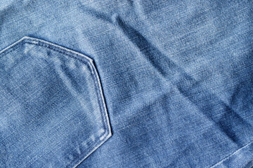 Blue jeans fabric texture. Distressed denim with back pocket background