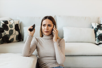 Young woman at home, looking stressed.