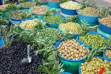 Olives assortment at outdoor market. Stall of colorful organic olives at farmers market. Healthy...