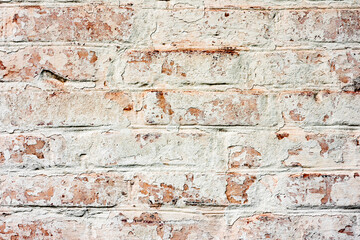 Texture of a brick wall with cracks and scratches which can be used as a background